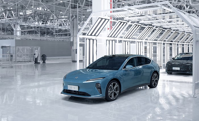 A blue car inside in a auto factory.