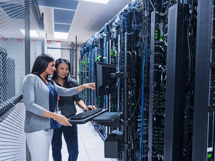 People looking at computer servers.