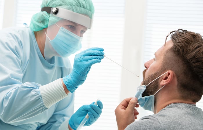 A person is swabbed by a doctor to test for a potential COVID-19 infection.