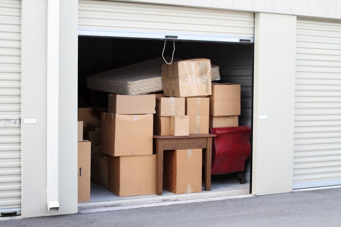 A storage unit filled with boxes and furniture.