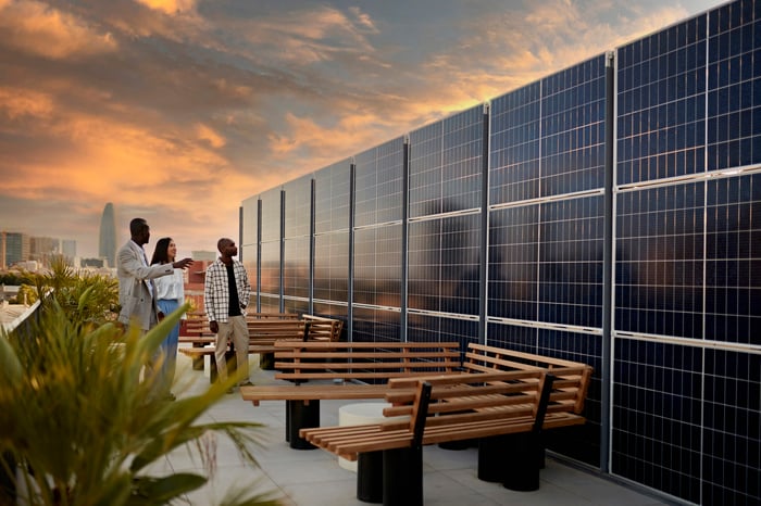 People on the terrace of an office building with views of the city.