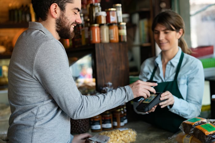 Man making a contactless payment at the store