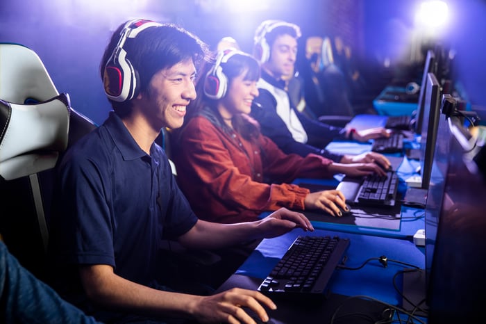 A group of people wearing headsets and gaming.