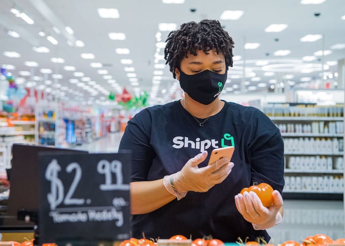 A Target Shipt worker scanning a product in a store.