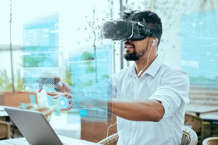 A person using a virtual reality headset while sitting in a cafe.