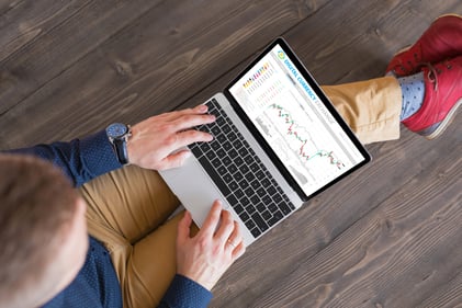 Person investing on computer getty