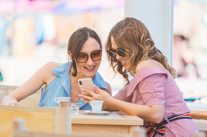Two people looking at a phone.
