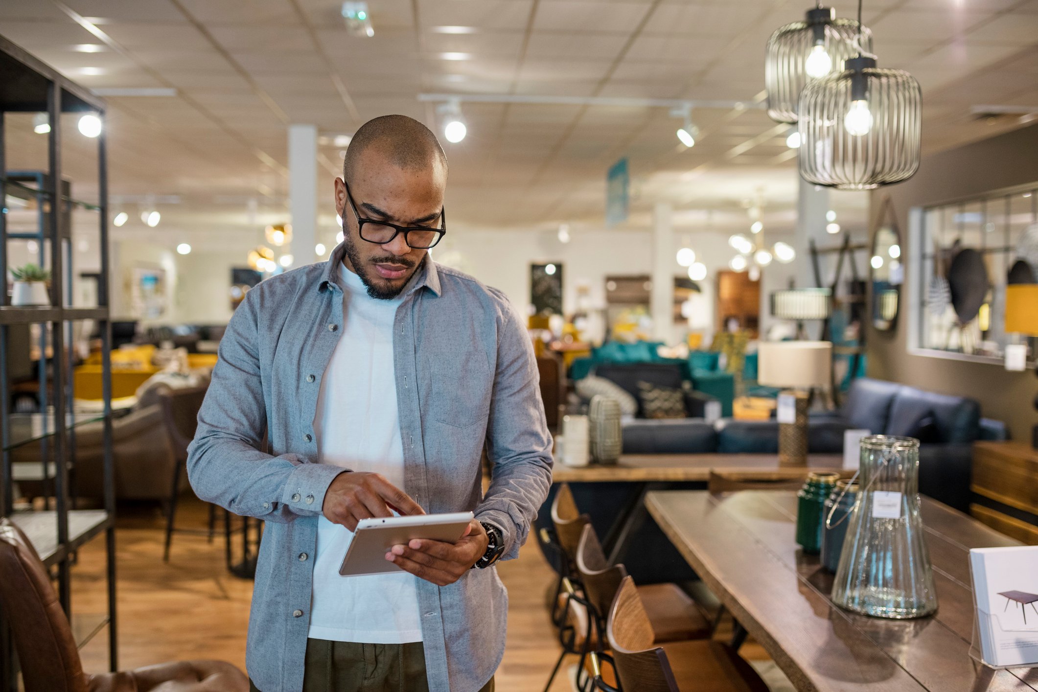 21_12_09 A person looking at a tablet in a store _GettyImages-1350603328