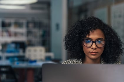 A person with a serious expression at a laptop_GettyImages-1309951436