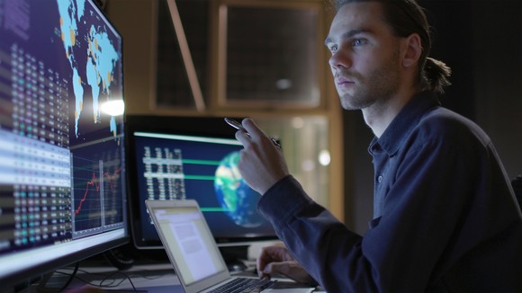 Person studying data on a screen.