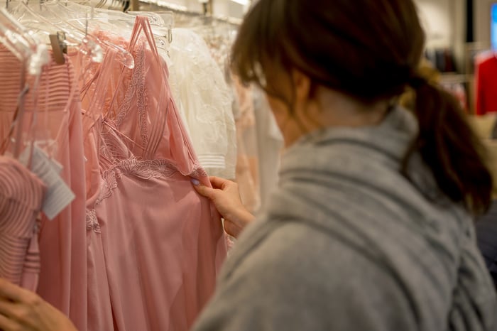 A person shopping in a clothing store.