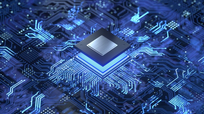 A digital rendering of a computer chip being plugged into a circuit board.