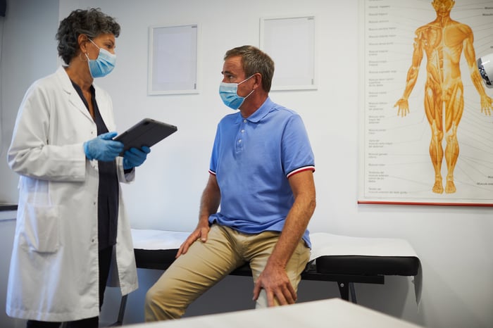 A doctor and patient talk to each other at an appointment.