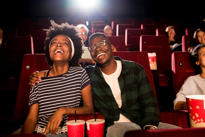 People in a movie theater enjoying a film.