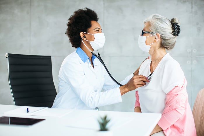 A doctor examines a patient during an appointment.