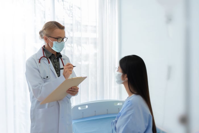 A doctor and patient talk with each other at an appointment.