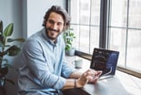 Person at their computer, smiling.
