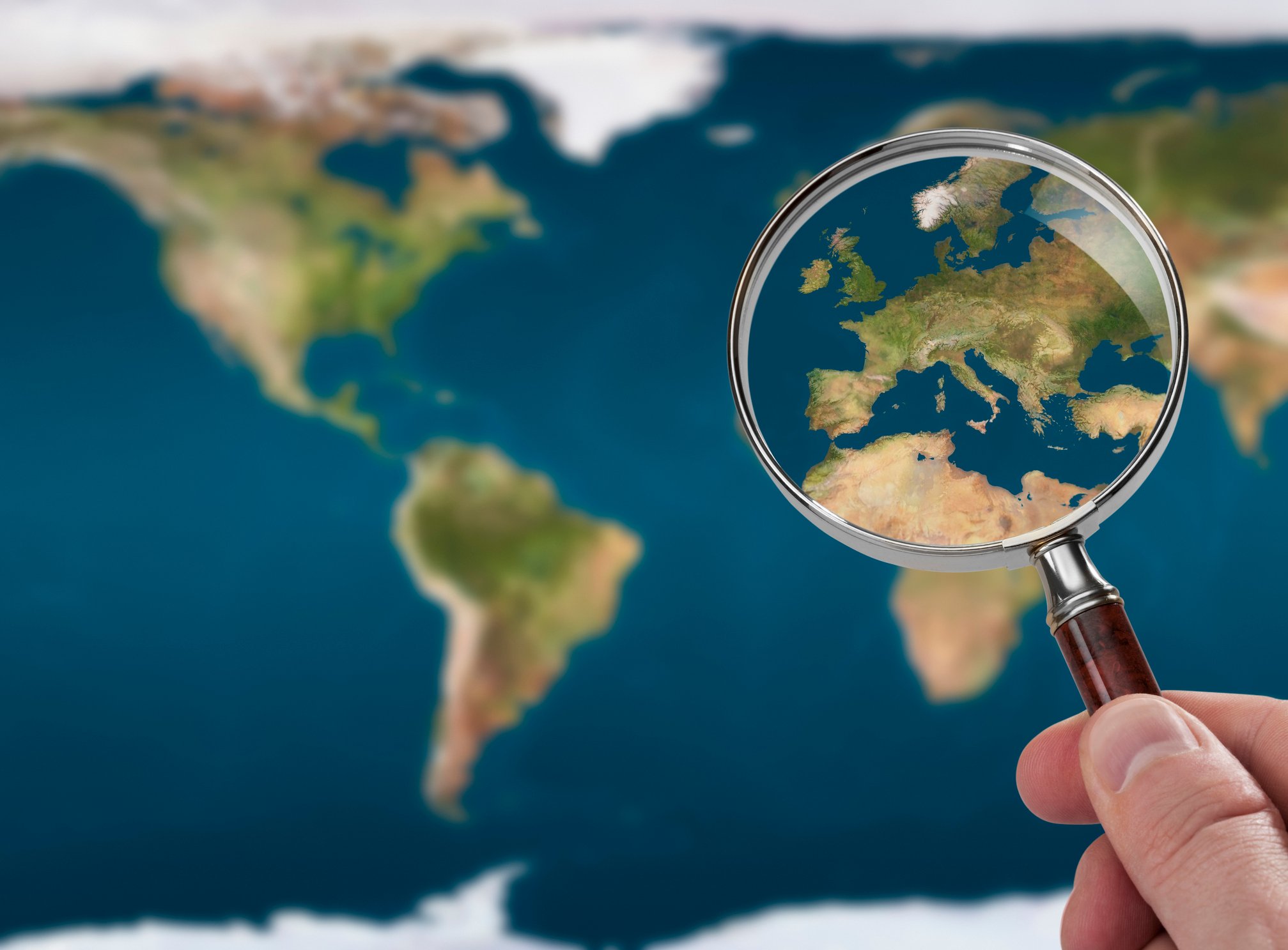 22_01_17 A magnifying glass hovered over Europe on a map _GettyImages-165581405