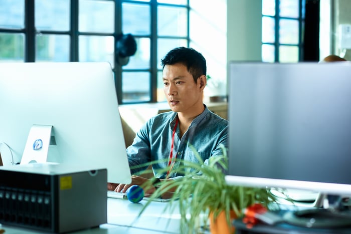 A person looking at a computer screen.
