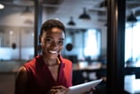 ambitious_smiling_woman_with_tablet_in_office