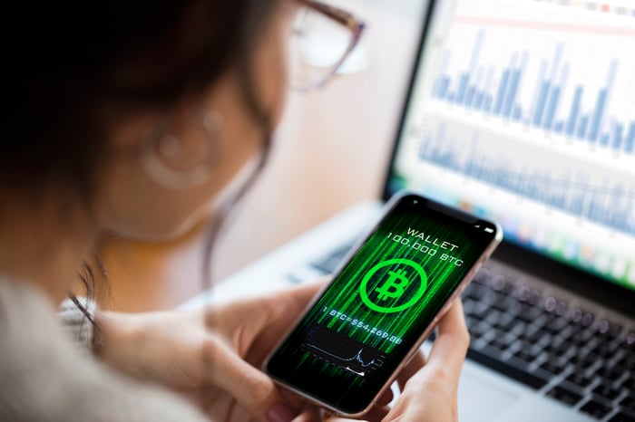 A person looks at a Bitcoin wallet on their phone.