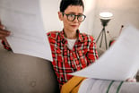Person looking at data on two spreadsheets.
