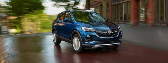 Blue Buick Encore GX against a blurred background.