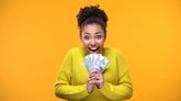 Young Woman holding Cash -- GettyImages-1142207897