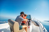 person with child driving boat