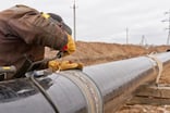 A worker repairing an oil pipeline.