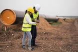 Engineers working at natural gas pipeline construction site.