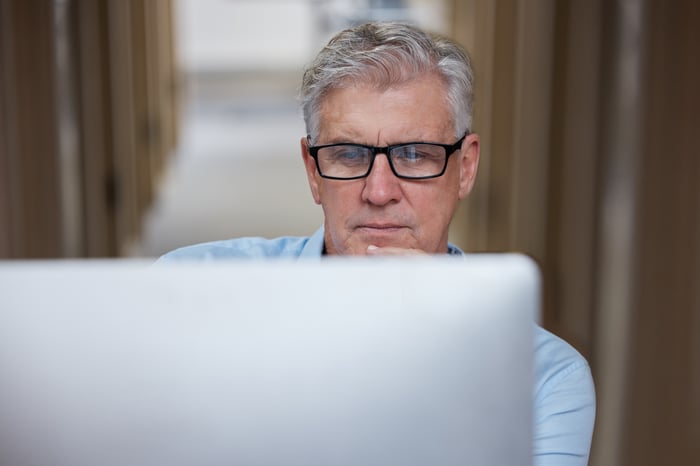 A person staring at a laptop.