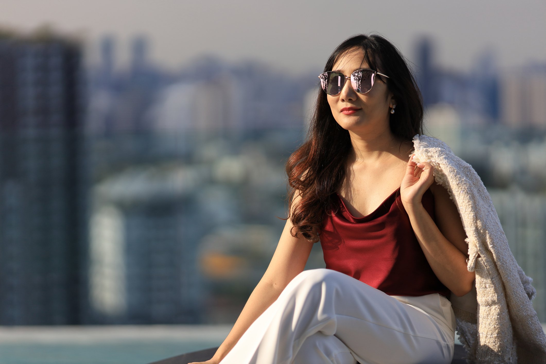 A person looking at view with cityscape behind them.