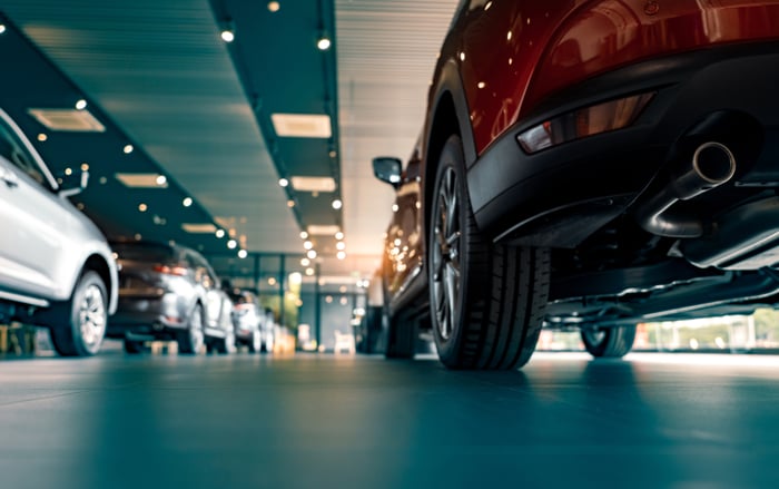 Cars on in an auto dealership showroom.