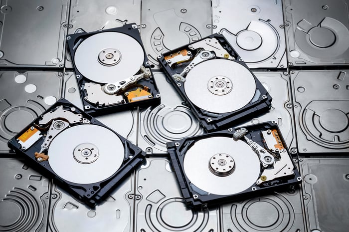 Four open hard drive disks placed on top of closed hard drive disks.