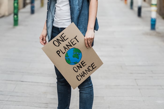 Protestor holding a sign reading One Planet One Chance.