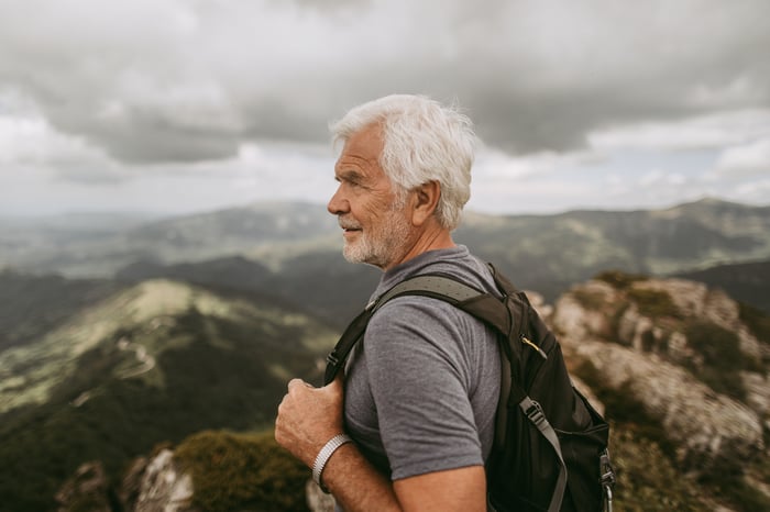 A person outdoors wearing a backpack.