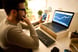 person-holding-a-phone-and-looking-at-a-chart-on-a-laptop