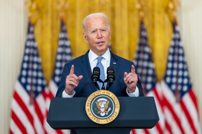 President Joe Biden delivering remarks while standing behind the Presidential lectern.