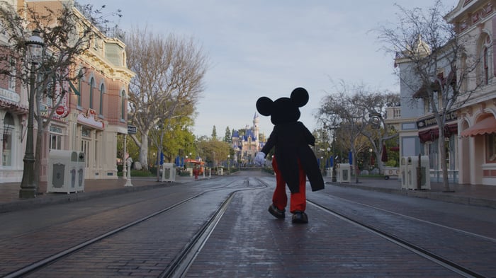 Mickey Mouse walks down Main Street USA.