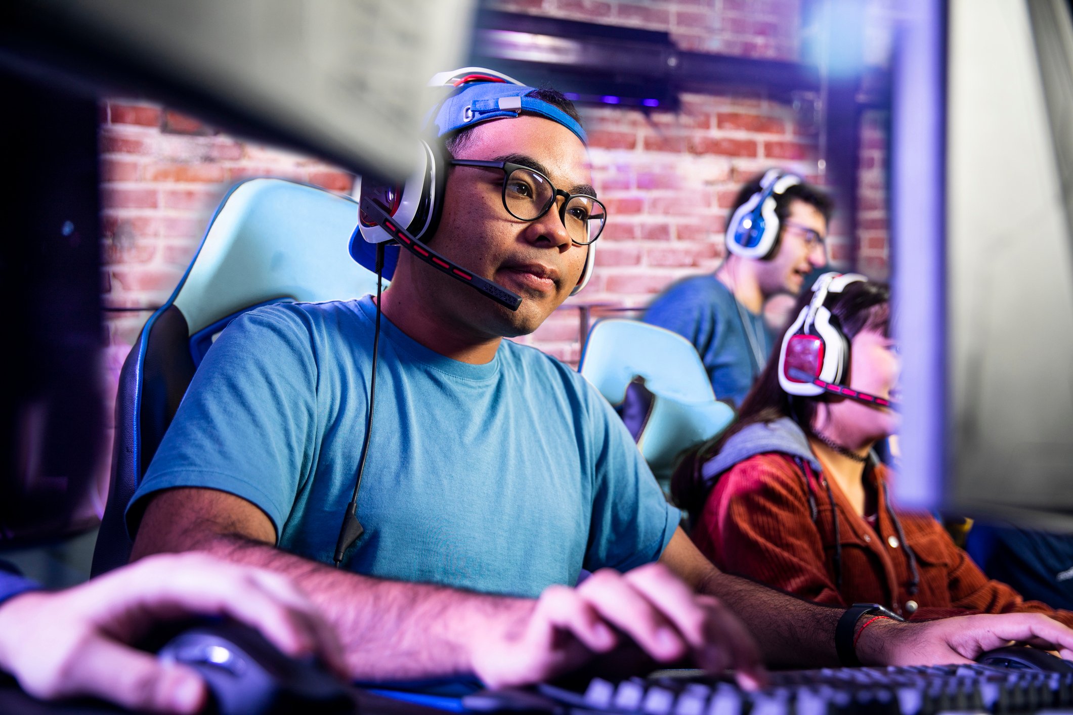a gamer wearing headset and playing video games on PC