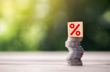 coins stacked percent block on top dividends interest