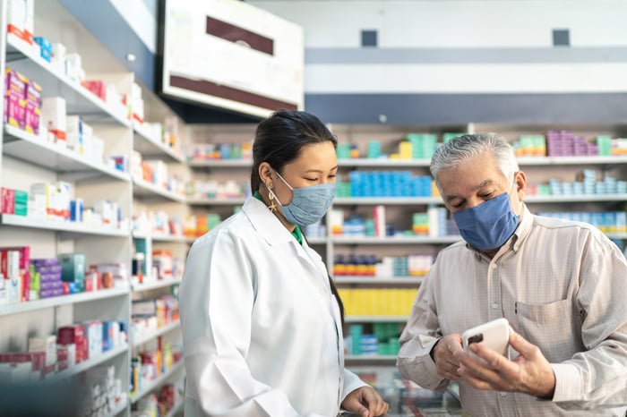 A pharmacist assists a customer.