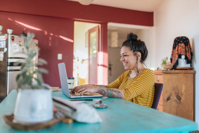 A person works on a laptop at home.