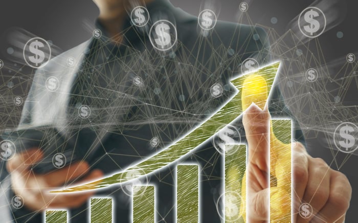 Investor pointing at a rising chart.