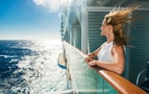 Happy woman looking at sea from a cruise ship