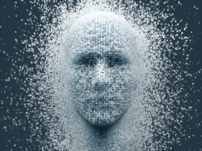 An computerized image of a human face appearing out of thousands of pixels. 