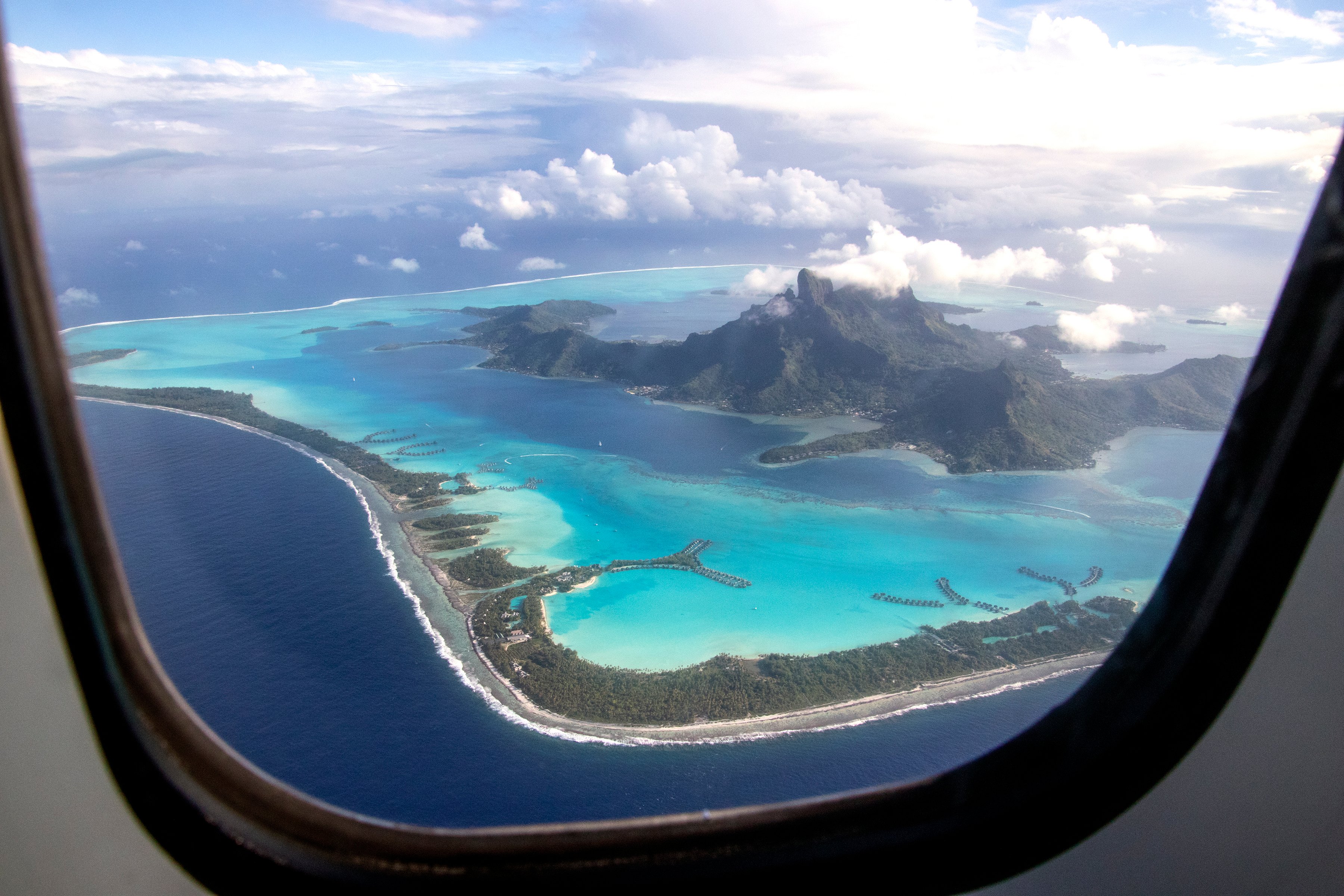 View of idyllic sea and land from the window of an airplane
