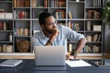 person thinking about a problem at a desk