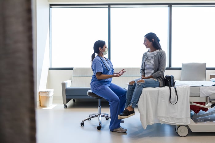 A doctor and patient talk to each other during an appointment.